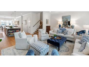 Bright and airy living room features stylish seating, area rug, and decor in a modern design at 810 Maple Berry Ln # 104, Raleigh, NC 27607