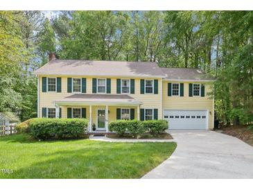 Charming two-story home with a well-manicured lawn and attached two-car garage at 106 Shady Point Ct, Durham, NC 27713