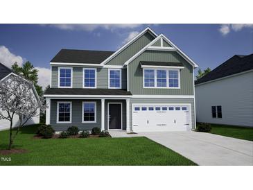 Charming two-story home with a mix of vertical and horizontal siding, covered porch, and a two-car garage at 129 Sagamore Ave., Angier, NC 27501