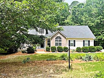 Charming single-Gathering home with beautiful landscaping and mature trees surrounding the property at 146 Bennett Pl, Clayton, NC 27527