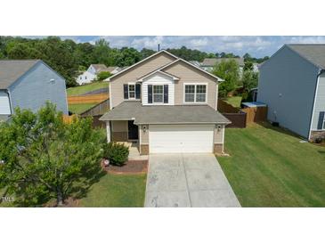 Two-story home with a two-car garage and manicured lawn in a residential neighborhood at 2527 Girvan Dr, Fuquay Varina, NC 27526