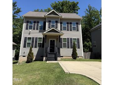 Charming two-story home features a well-manicured lawn and classic black shutters, creating inviting curb appeal at 317 Chamberlain Dr, Clayton, NC 27527