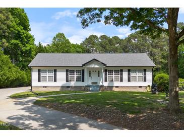 Charming single-story home with a well-manicured lawn and inviting front porch at 4022 Avents Ferry Rd, Sanford, NC 27330