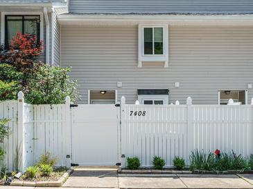 Charming exterior with white picket fence and neat landscaping adds curb appeal to the property at 7408 Sandy Creek Dr, Raleigh, NC 27615