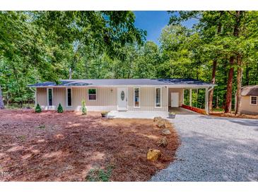 Charming ranch-style home with a well-manicured lawn and covered front entrance, perfect for outdoor living at 9614 Quail Roost Rd, Bahama, NC 27503