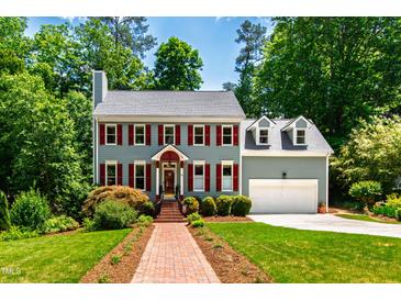 Charming two-story home featuring a brick walkway and well-maintained landscaping at 105 Juniper Ct, Carrboro, NC 27510