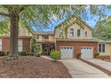 Charming two-story home featuring a brick foundation and attached two-car garage at 11035 Southwalk Ln, Raleigh, NC 27614