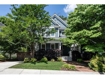 Charming two-story home with blue siding and a well-manicured front yard, shaded by mature trees at 1313 Dale St, Raleigh, NC 27605