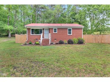 Charming brick home with a bright red roof and well-manicured lawn at 774 Salem Church Rd, Sanford, NC 27330