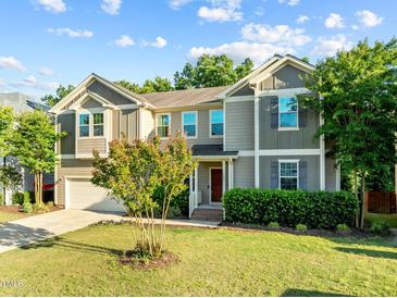 Charming two-story home with manicured lawn and beautiful landscaping at 109 Highland Mist Cir, Apex, NC 27539