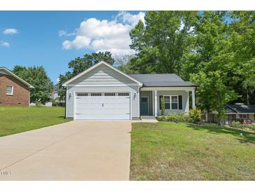 Charming single-story home with a two-car garage and well-maintained front yard at 15 Nottingham Pl, Smithfield, NC 27577