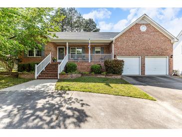 Charming brick home featuring an inviting front porch, manicured landscaping, and a two-car garage at 1732 Bobwhite Ln, Rocky Mount, NC 27804