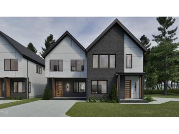 Modern two-story home boasts a combination of gray brick and white siding and a well manicured lawn at 1802 Pershing Rd, Raleigh, NC 27608