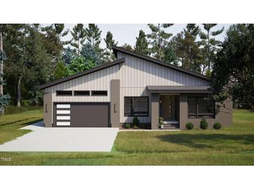 Modern exterior with horizontal siding and a dark gray garage door at 269 Deer Tail Ln # 44, Fuquay Varina, NC 27526