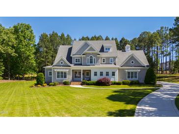 Stunning gray house boasts a manicured lawn and mature trees at 6 Castlewood Dr, Durham, NC 27713