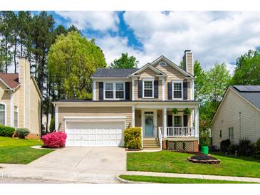 Charming two-story home with a well-manicured lawn and inviting front porch at 8613 Swarthmore Dr, Raleigh, NC 27615