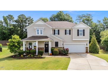 Charming two-story home with a manicured lawn and welcoming front porch, great curb appeal at 108 Yosemite Ct, Holly Springs, NC 27540
