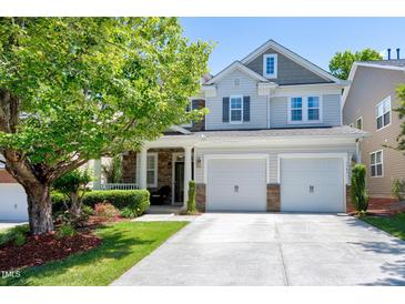 Beautiful two-story home with a two car garage and a well-manicured lawn, perfect for families at 1141 Brookhill Way, Cary, NC 27519