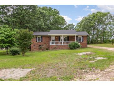 Charming brick home with a welcoming front porch and freshly cut lawn at 2670 Nc 210 S, Lillington, NC 27546