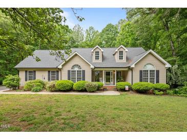 Charming home with manicured lawn and mature landscaping offers great curb appeal at 2917 Kesler Trl, Mebane, NC 27302