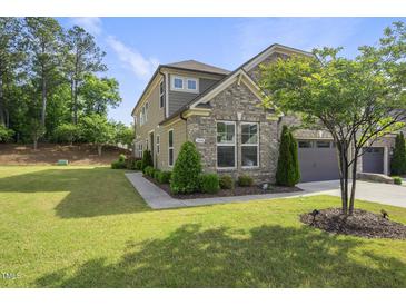 Beautiful two-story home featuring a brick and siding exterior and a well-manicured lawn at 3406 Antler View Dr, Apex, NC 27502