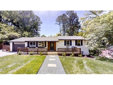 Charming single-story home with a modern black and white exterior and welcoming front porch at 4501 Rockwood Dr, Raleigh, NC 27612