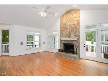 Bright living room with vaulted ceilings, hardwood floors, and a stone fireplace at 5241 Mill Dam Rd, Wake Forest, NC 27587
