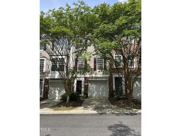 Charming townhome with a well-maintained lawn, garage and mature trees providing shade at 5310 Echo Ridge Rd, Raleigh, NC 27612