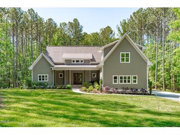 Charming home featuring a well-manicured lawn and inviting front entrance at 59 Mill Rd, Pittsboro, NC 27312