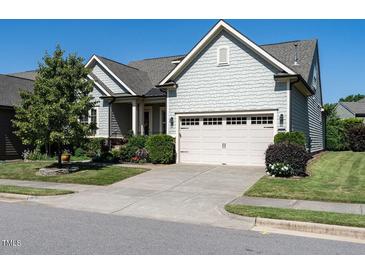 Charming single-Gathering home with a two-car garage, landscaped yard, and light gray siding at 8461 Lentic Ct, Raleigh, NC 27615