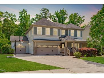 Inviting two-story home with a three-car garage, basketball hoop, and well-maintained lawn at 1401 Everette Fields Rd, Morrisville, NC 27560