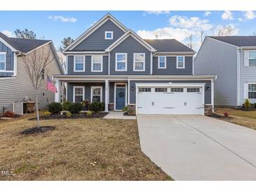 Beautiful two-story home with a well-manicured lawn and attached two-car garage at 168 Amber Acorn Ave, Raleigh, NC 27603