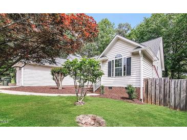 Charming home featuring manicured lawn, mature trees, and classic white siding at 1808 Betry Pl, Raleigh, NC 27603
