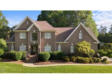 Charming two-story brick home with a manicured lawn and mature landscaping providing great curb appeal at 2037 Gurney Ct, Burlington, NC 27215