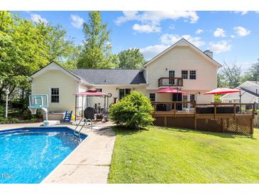 Expansive backyard featuring a well-maintained pool, spacious deck and patio perfect for entertaining at 2113 Port Royal Rd, Raleigh, NC 27609
