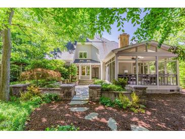 Charming home with a well-manicured front yard and stone walkway leading to a covered porch at 300 Livingstone Dr, Cary, NC 27513