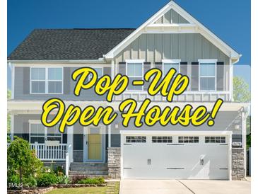 Charming two-story home with a well-manicured lawn, inviting curb appeal, and a welcoming front porch at 3678 Horton Hill Dr, New Hill, NC 27562