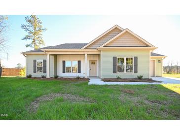 Charming one-story home with a well-maintained lawn and inviting entrance at 404 S Eastwood Dr, Benson, NC 27504
