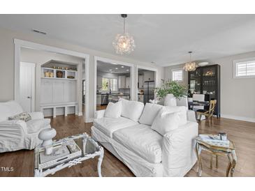 Bright and airy living room with hardwood floors and open floor plan showcasing modern interior design at 43 Quarter Gate Trce, Chapel Hill, NC 27516
