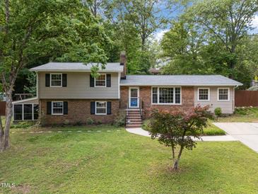 Charming two-story home with brick and siding exterior, manicured lawn, and mature trees offering curb appeal at 600 Longleaf Dr, Chapel Hill, NC 27517