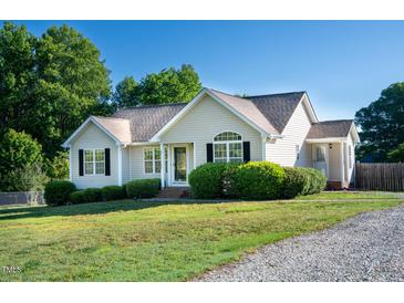 Charming one-story home featuring a well-maintained lawn and manicured landscaping at 78 Cross Creek Ct, Timberlake, NC 27583