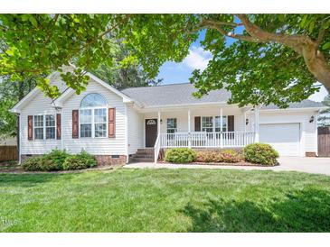Charming single-story home with a well-manicured lawn and inviting front porch at 901 N Taylor St, Wake Forest, NC 27587