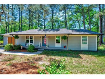 Charming single-story home with a welcoming front porch and well-maintained landscaping at 9220 Old Cascade Dr, Garner, NC 27529