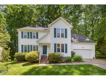 Charming two-story home with a well-manicured lawn and traditional architectural details and a 2 car garage at 9408 Bells Valley Dr, Raleigh, NC 27617