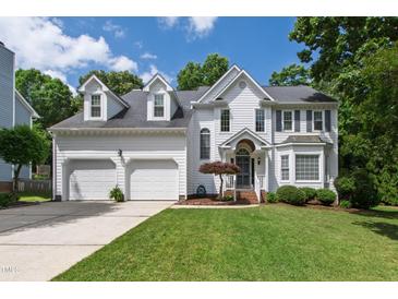 Charming two-story home with an attached two-car garage and a well-maintained front yard at 9517 Candor Oaks Dr, Raleigh, NC 27615