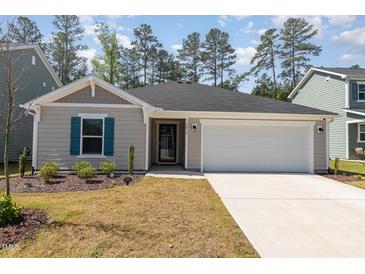 Charming single-story home with a well-maintained lawn, attached garage, and inviting curb appeal at 1012 Ringhill Bluff Dr, Durham, NC 27704