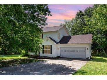 Charming two-story home with a two-car garage and lush greenery in a well-maintained neighborhood at 105 Hiddenwood Ct, Garner, NC 27529