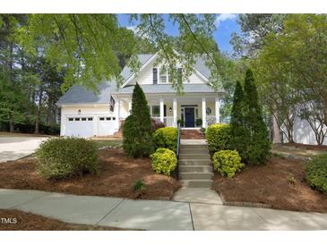 Charming two-story home with manicured front yard and inviting entrance staircase at 1605 Heritage Club Ave, Wake Forest, NC 27587