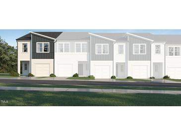 Modern townhome exterior showcasing a sleek design and well-manicured landscaping at 3004 Vitner Dr, Durham, NC 27704