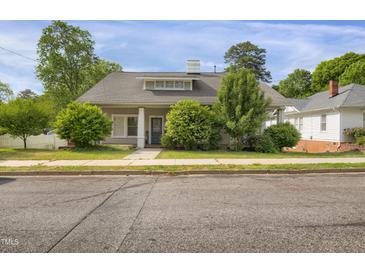 Charming single-story home with well-maintained landscaping and inviting curb appeal at 312 Green St, Sanford, NC 27330